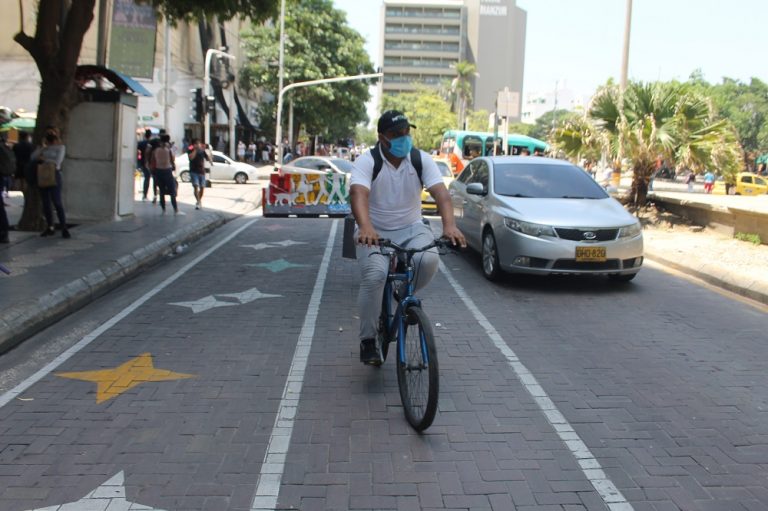 Ciclista y carro por el Paseo Bolívar