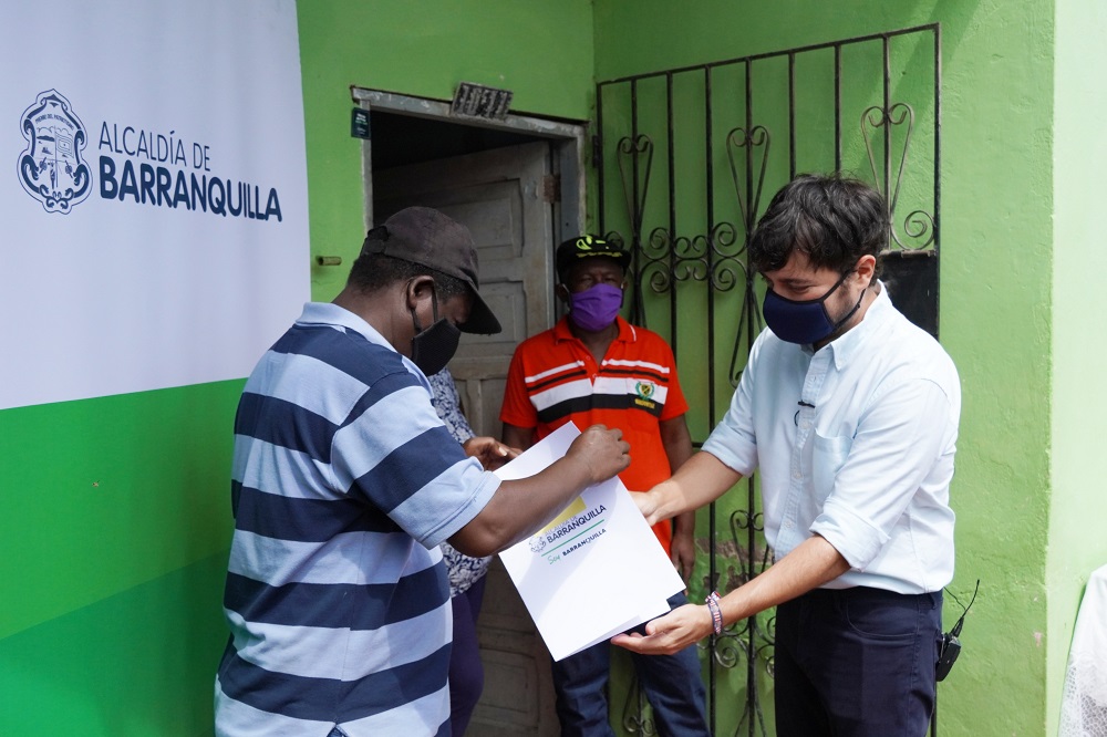 Hombre recibiendo título de vivienda