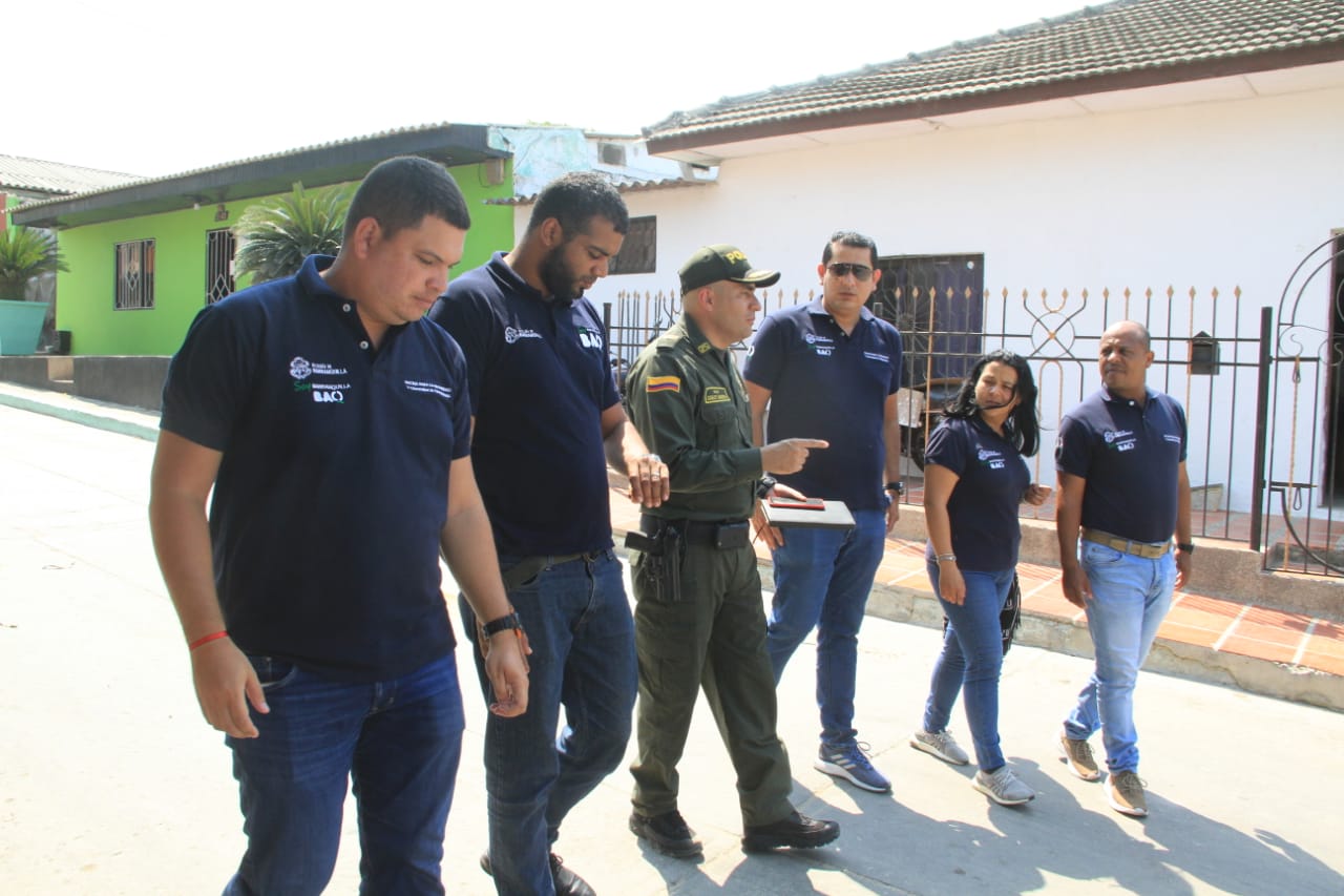 Policía junto a funcionarios de Oficina de Seguridad caminan por un barrio