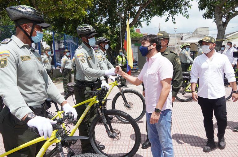 Alcalde Pumarejo saludando a policías en bicicleta.