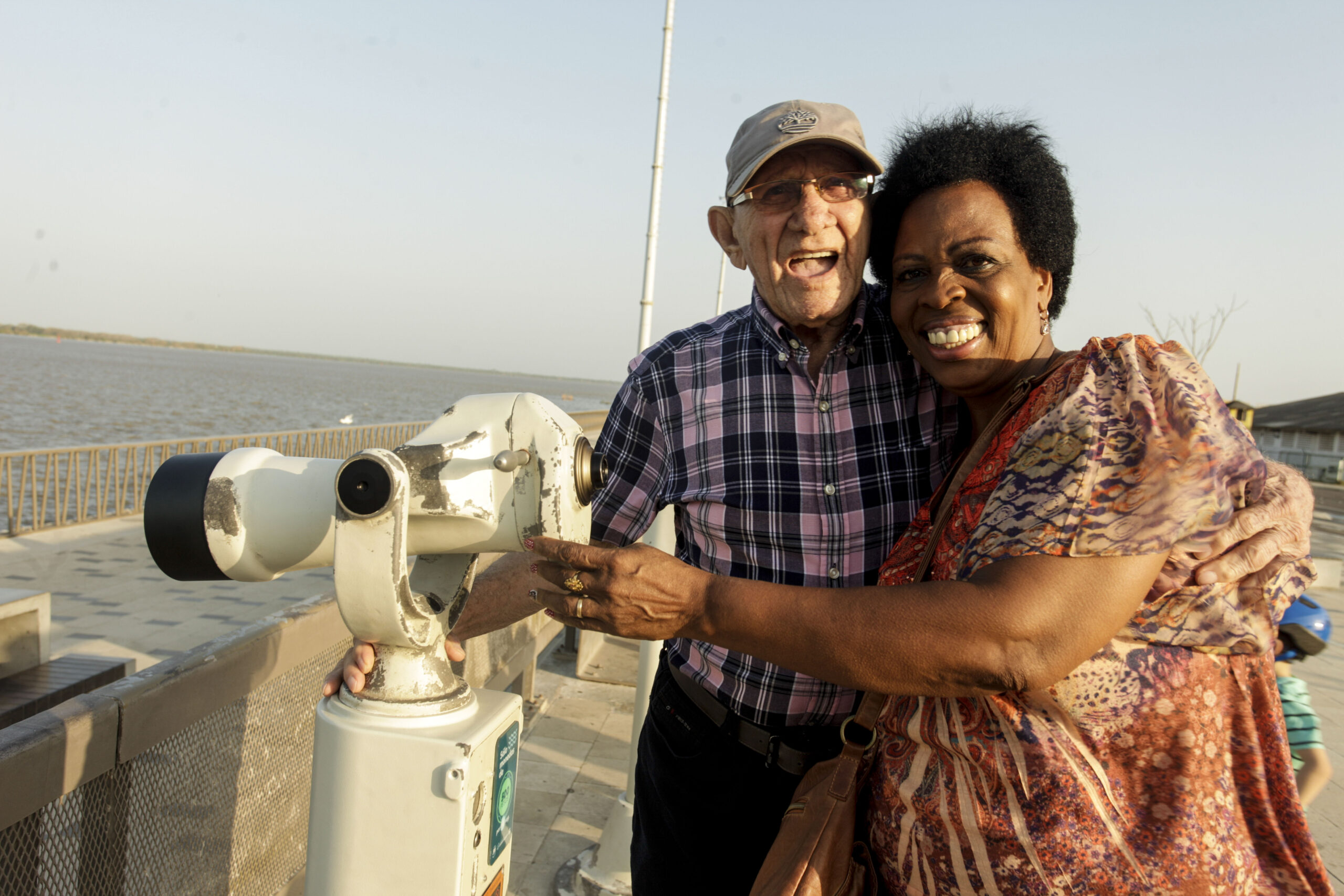 Pareja de tercera edad sonriendo en el malecón