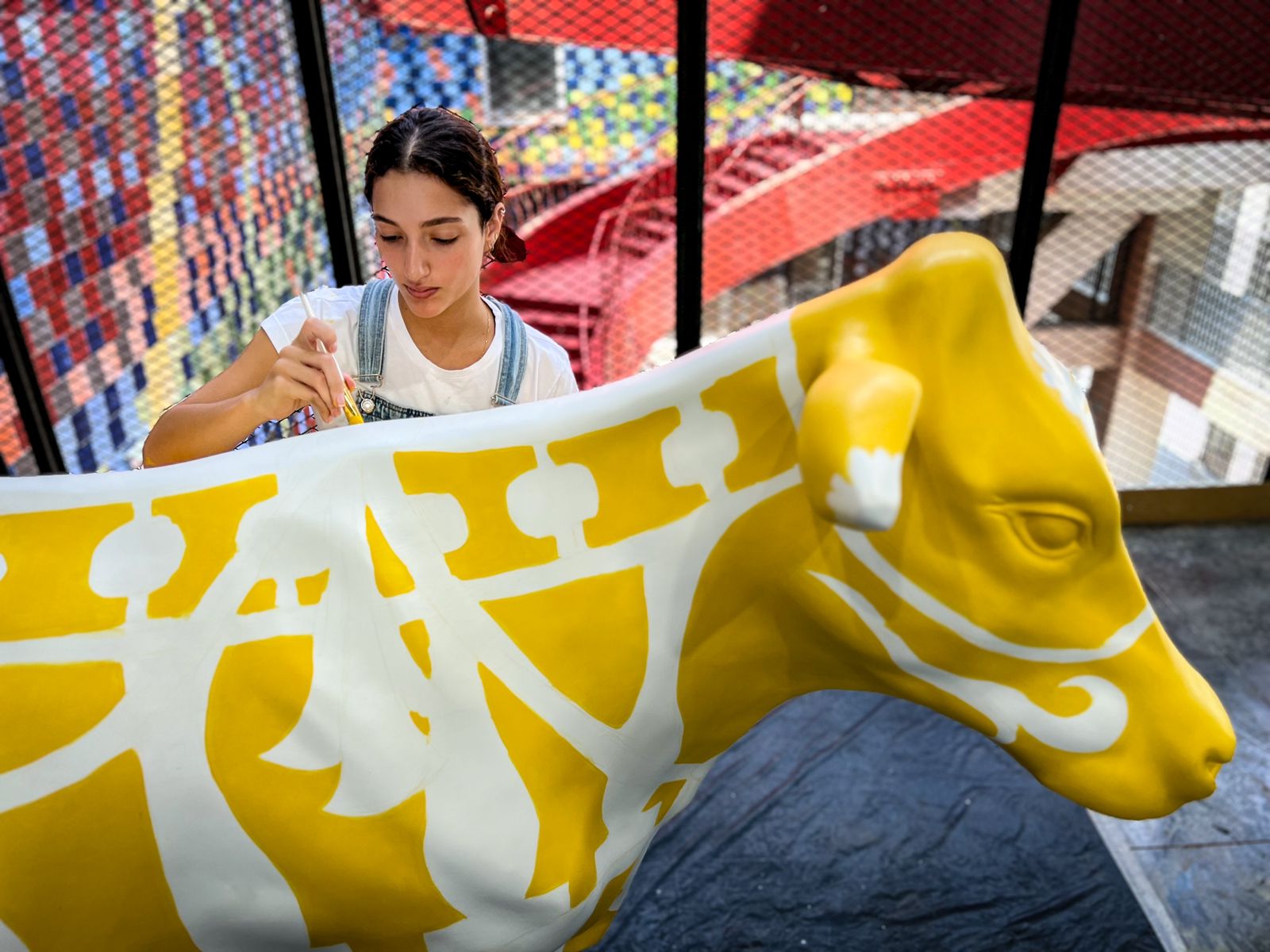 Artista trabajando sobre unua de las obra vacasquilla