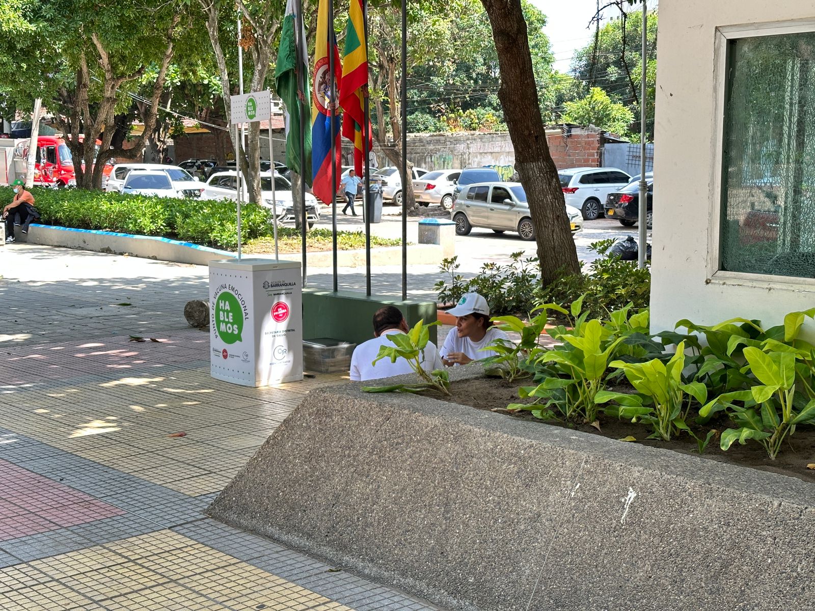 Dos personas dialogando sentadas en el piso de un Cai