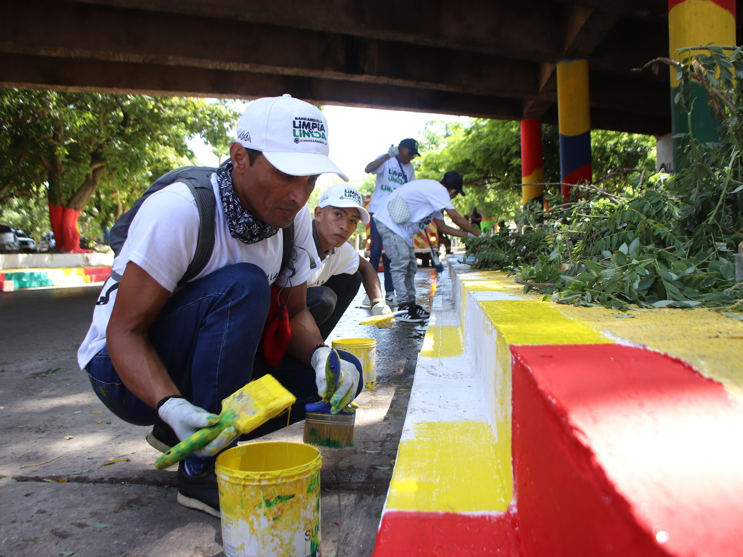 Grupo de personas pintando bordillos durante jornada recuperación espacios.