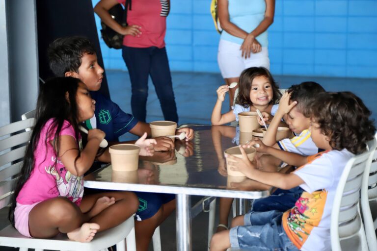 Grupo de niños almorzando en Comedor Comunitario.