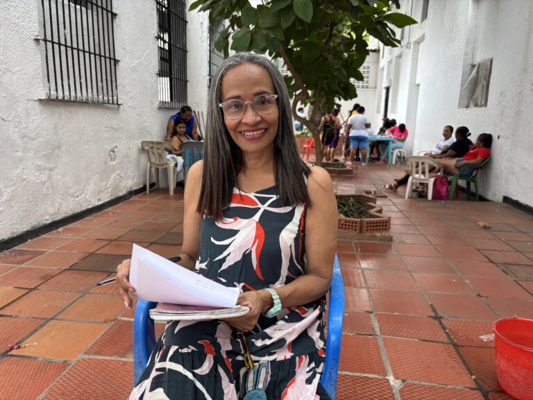 Diana Montiel posa en primer plano sentada en una silla con unas hojas en la mano.
