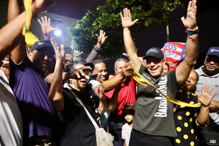 Alcalde con comunidad alzando las manos