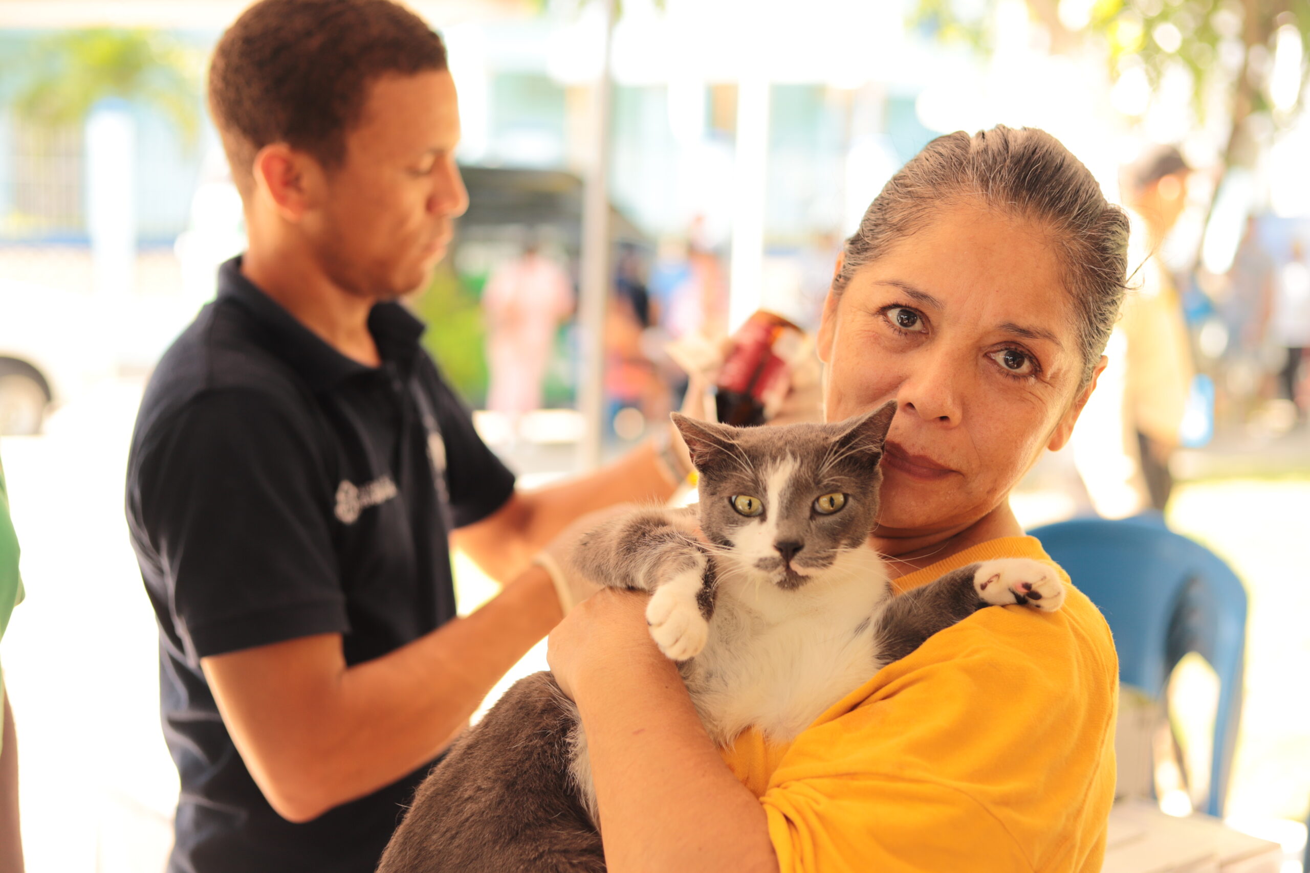 Ciudadana sosteniendo a su mascota en una jornada de bienestar animal