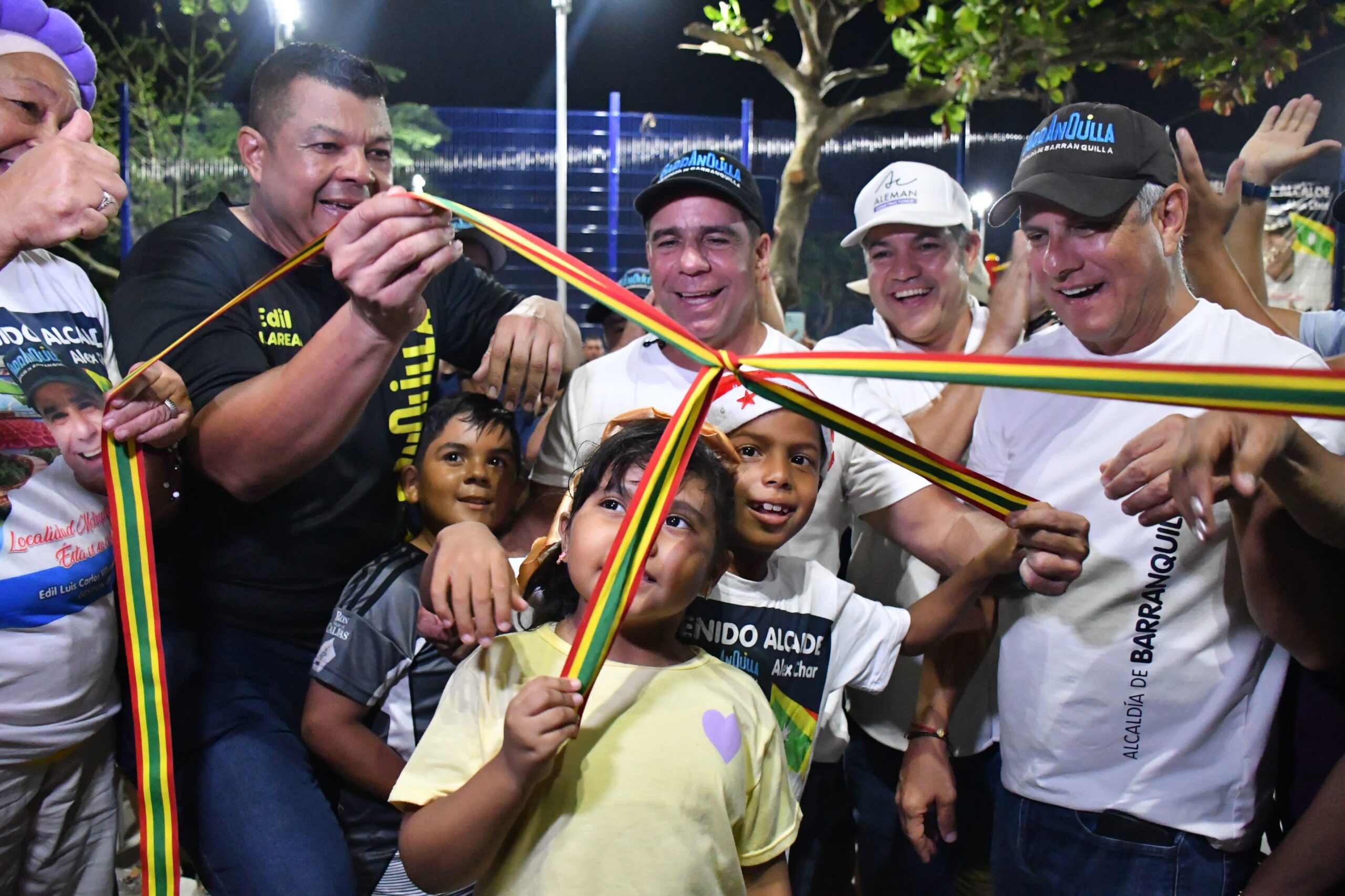 El Acalde Alejandro Char sosteniendo y cortando junto con varias persona una cinta tricolor (amarillo, rojo y verde)